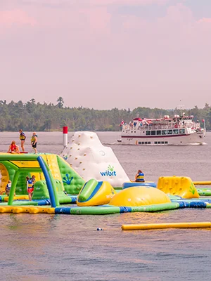 Hoopla Island on the water with the MS Kenora sailing in the background
